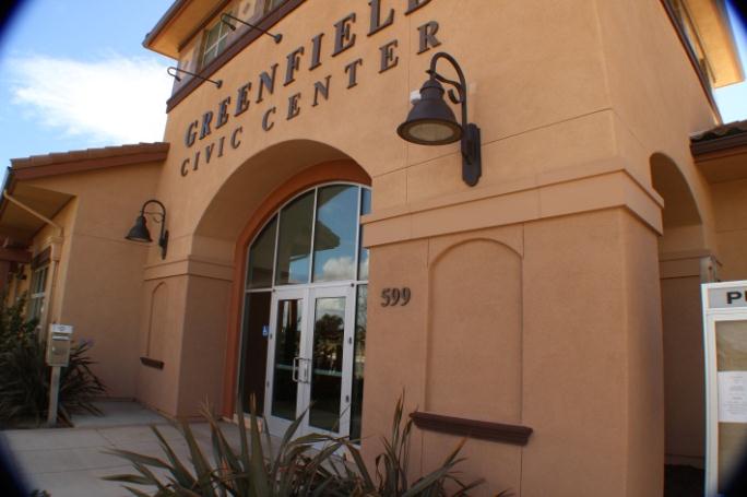 The Greenfield Civic Center. It is a tan building with glass doors.